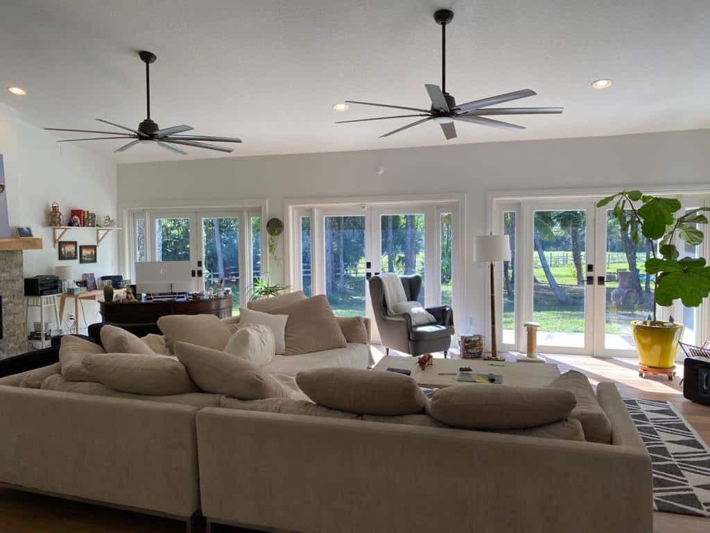 open plan living room with ceiling fans