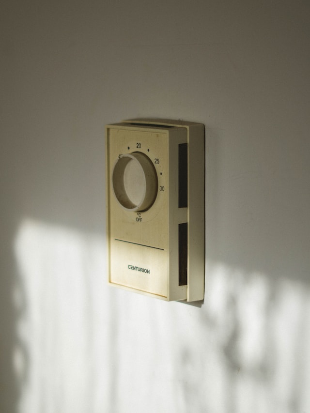 older style wall fixed thermostat